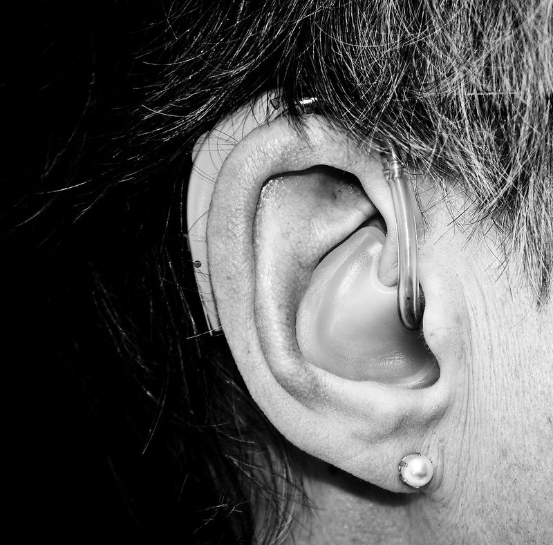 hearing aid in ear with earring